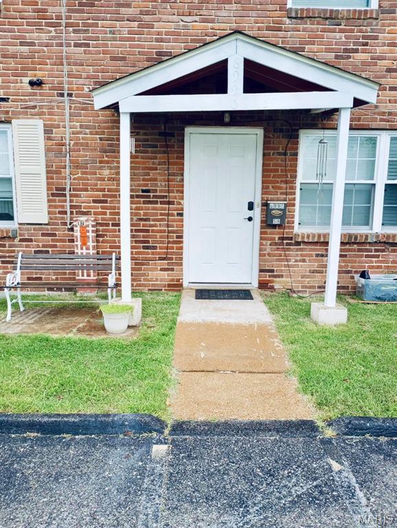 6990 Colonial Woods Dr Unit 59, Saint Louis, MO 63129 - view of exterior entry featuring brick siding