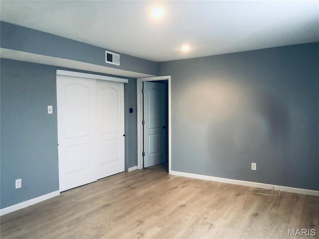 6990 Colonial Woods Dr Unit 59, Saint Louis, MO 63129 - unfurnished bedroom with baseboards, wood finished floors, and a closet