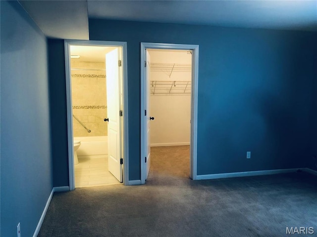 6990 Colonial Woods Dr Unit 59, Saint Louis, MO 63129 - unfurnished bedroom with carpet floors, baseboards, a spacious closet, and a closet