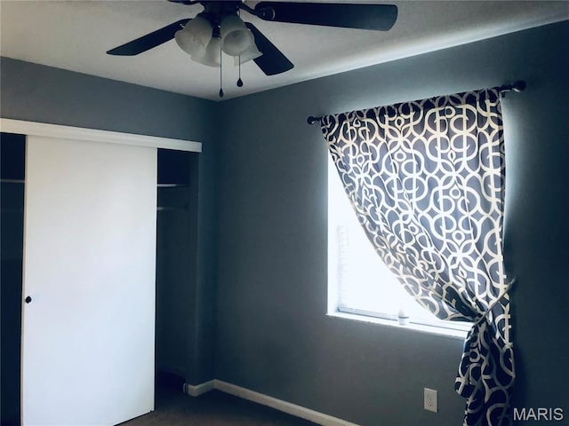 6990 Colonial Woods Dr Unit 59, Saint Louis, MO 63129 - unfurnished bedroom featuring carpet floors, a ceiling fan, and a closet