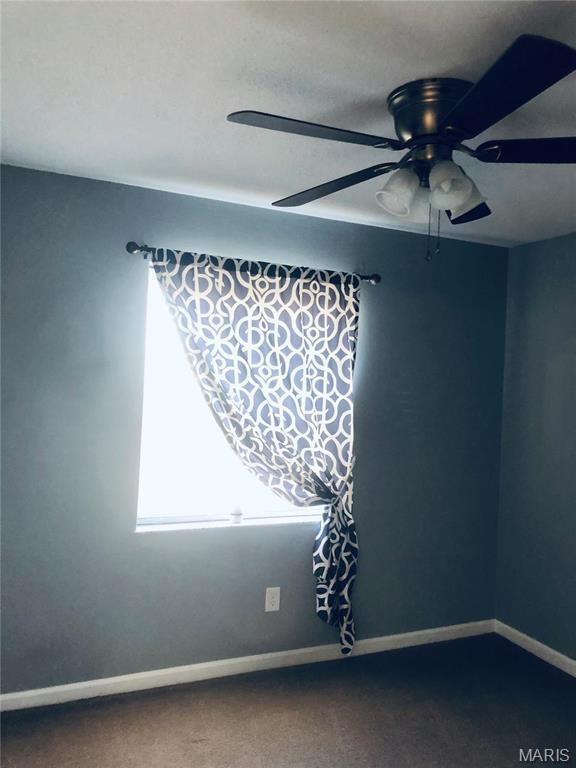 6990 Colonial Woods Dr Unit 59, Saint Louis, MO 63129 - unfurnished room with ceiling fan, carpet, and baseboards