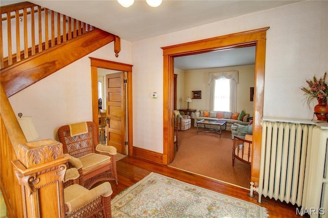 502 N State St, Jerseyville, IL 62052 - living area featuring radiator heating unit, wood finished floors, and baseboards