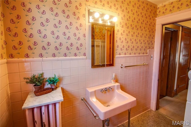 502 N State St, Jerseyville, IL 62052 - bathroom featuring wallpapered walls, a wainscoted wall, tile walls, and a sink