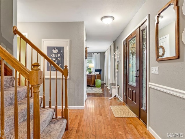 157 Knob Creek Ln, Ofallon, IL 62269 - foyer entrance with light wood-style flooring, a textured wall, and stairs