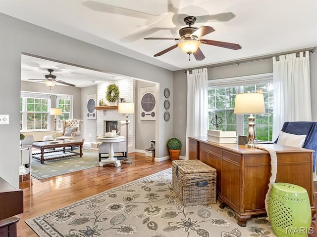 157 Knob Creek Ln, Ofallon, IL 62269 - office space with a ceiling fan, plenty of natural light, light wood-style flooring, and a fireplace