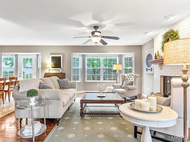 157 Knob Creek Ln, Ofallon, IL 62269 - living room featuring wood finished floors, a ceiling fan, healthy amount of natural light, and a brick fireplace