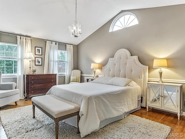 157 Knob Creek Ln, Ofallon, IL 62269 - bedroom with vaulted ceiling, a chandelier, and wood finished floors