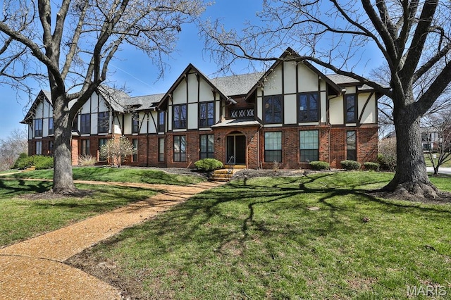 917 Claytonbrook Dr Unit 4, Ballwin, MO 63011 - tudor home with stucco siding, brick siding, and a front lawn