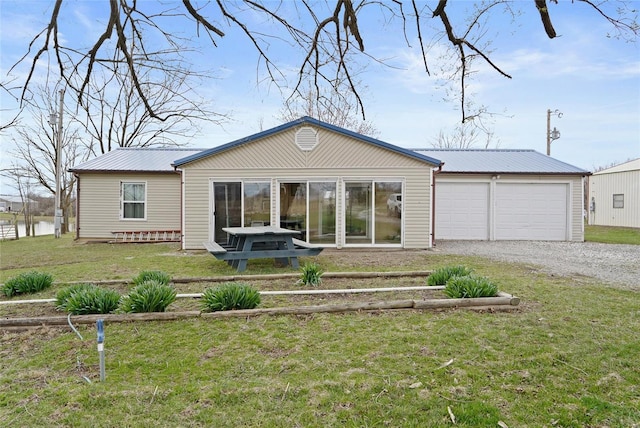23425 N Everett Carr Rd, Mo, MO 65243 - back of property with gravel driveway, metal roof, a lawn, and a garage