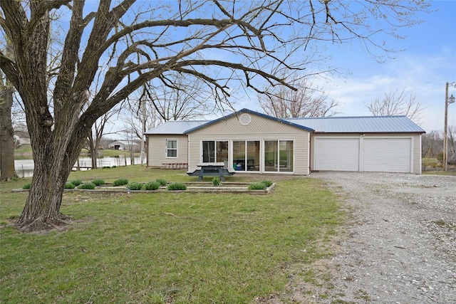 23425 N Everett Carr Rd, Mo, MO 65243 - view of front of home featuring gravel driveway, metal roof, a front yard, and a garage