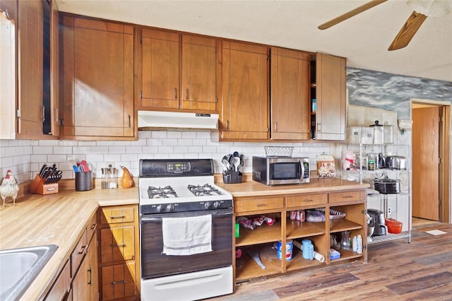 23425 N Everett Carr Rd, Mo, MO 65243 - kitchen with range with gas cooktop, stainless steel microwave, under cabinet range hood, light countertops, and ceiling fan