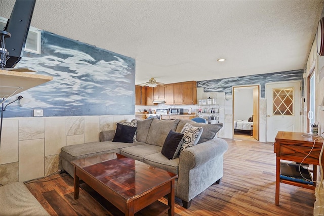 23425 N Everett Carr Rd, Mo, MO 65243 - living room featuring wallpapered walls, wood finished floors, a textured ceiling, and recessed lighting