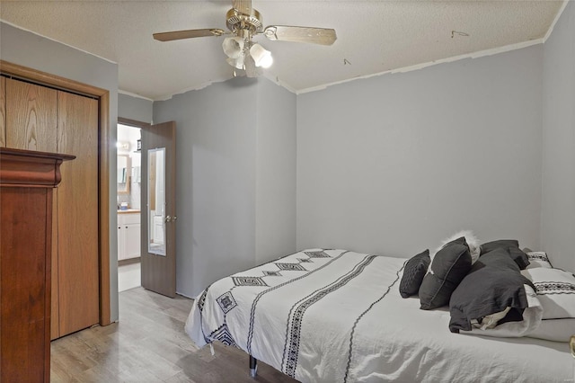 23425 N Everett Carr Rd, Mo, MO 65243 - bedroom featuring light wood-type flooring, crown molding, a textured ceiling, and a ceiling fan