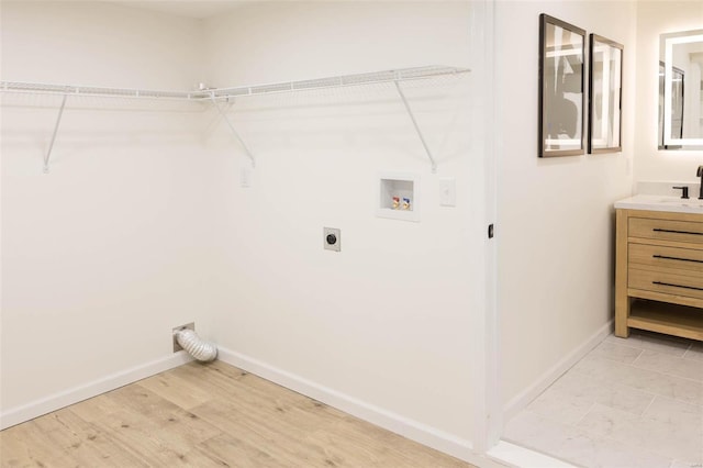 407 Front St, Monroe City, MO 63456 - washroom with electric dryer hookup, washer hookup, baseboards, and light wood-type flooring