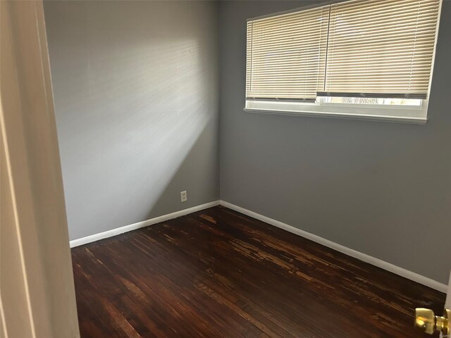 10314 Viscount Dr, Saint Louis, MO 63136 - empty room with dark wood-style flooring, baseboards, and plenty of natural light