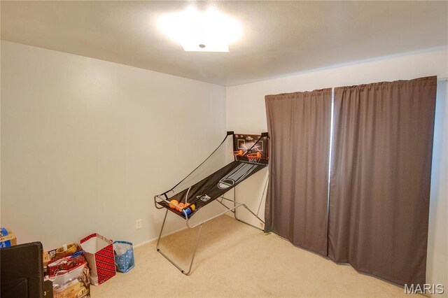game room featuring light colored carpet