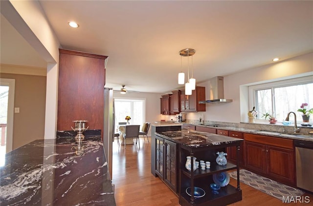 kitchen featuring wall chimney exhaust hood, a sink, appliances with stainless steel finishes, wood finished floors, and open shelves
