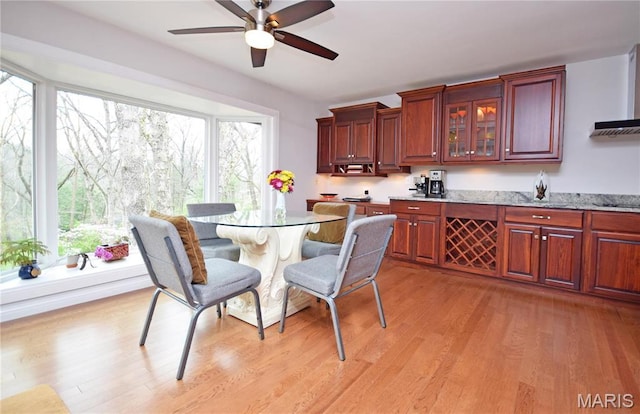 dining area featuring light wood-style flooring and ceiling fan