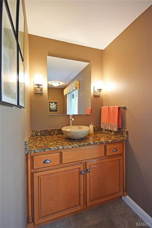 bathroom featuring vanity, baseboards, and tile patterned floors