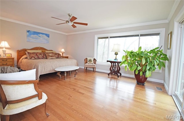 bedroom with light wood-style flooring, crown molding, baseboards, and ceiling fan