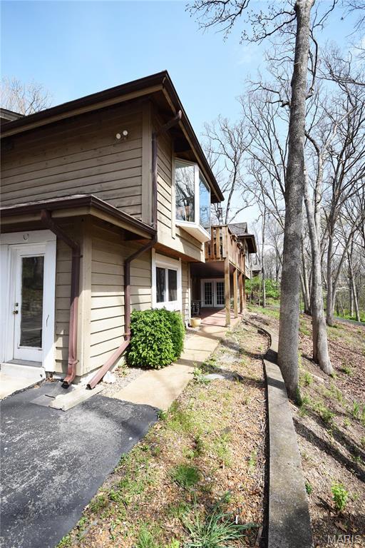 view of property exterior with a deck