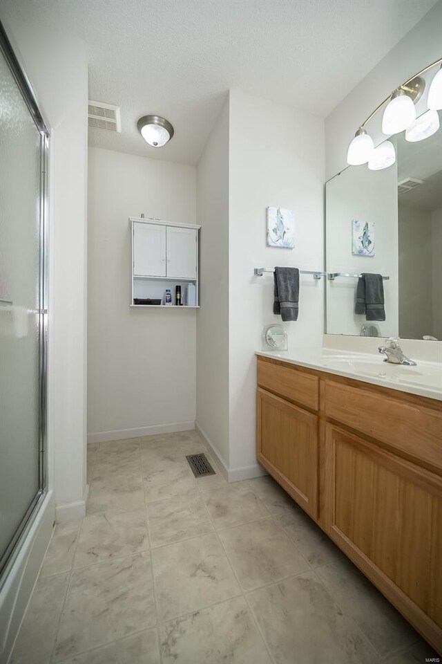 173 Silo View Dr Unit 393A, Wentzville, MO 63385 - full bath with an enclosed shower, vanity, and baseboards