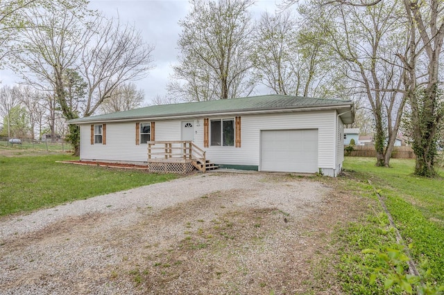 1425 Cedar Dr, Lebanon, MO 65536 - single story home featuring dirt driveway, a garage, and metal roof