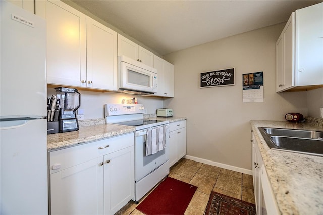 1425 Cedar Dr, Lebanon, MO 65536 - kitchen featuring white appliances, baseboards, white cabinetry, a sink, and light tile patterned floors