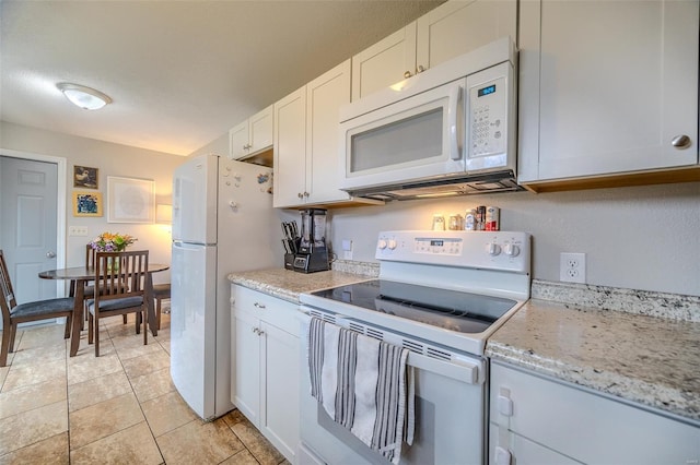 1425 Cedar Dr, Lebanon, MO 65536 - kitchen featuring white appliances, white cabinetry, light stone counters, and light tile patterned floors