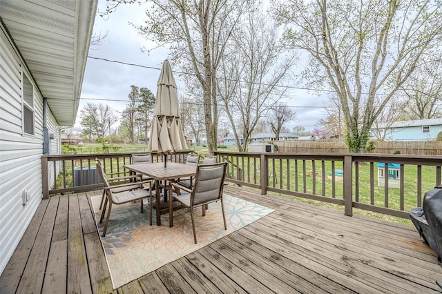 1425 Cedar Dr, Lebanon, MO 65536 - wooden deck featuring a fenced backyard and outdoor dining area