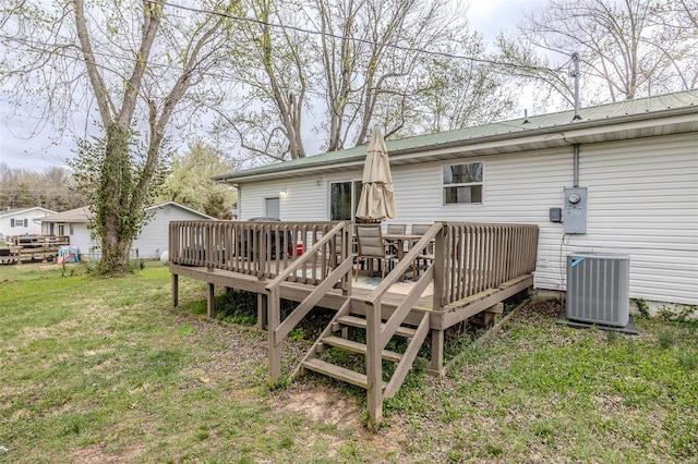 1425 Cedar Dr, Lebanon, MO 65536 - back of property with cooling unit, a deck, metal roof, and a yard
