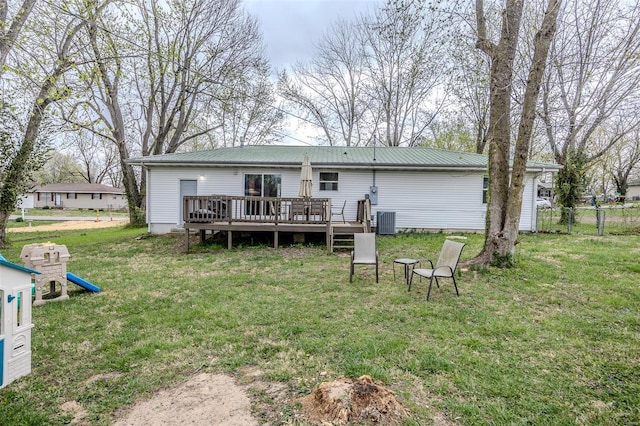 1425 Cedar Dr, Lebanon, MO 65536 - rear view of house with a wooden deck, metal roof, and central air condition unit