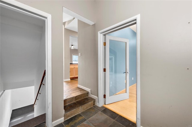5089 Waterman Blvd, Saint Louis, MO 63108 - corridor featuring stone tile flooring, an upstairs landing, and baseboards