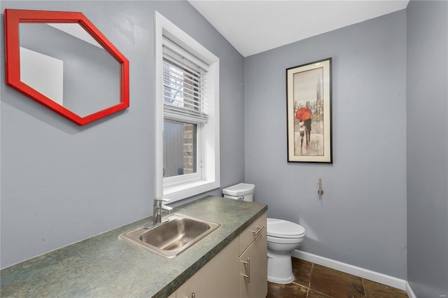 5089 Waterman Blvd, Saint Louis, MO 63108 - bathroom with toilet, baseboards, and vanity