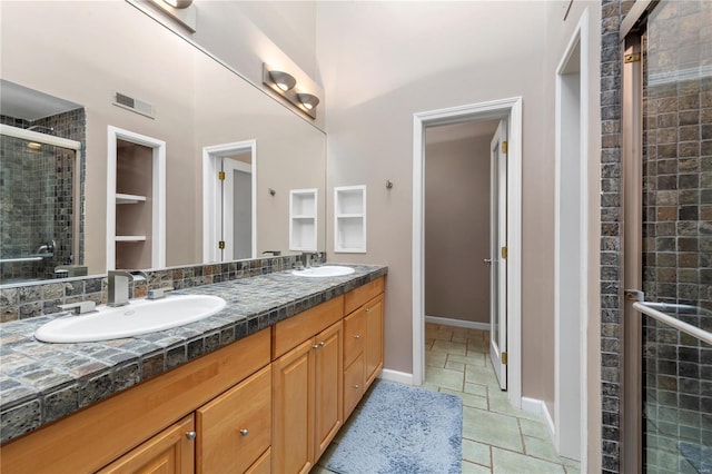 5089 Waterman Blvd, Saint Louis, MO 63108 - bathroom with a shower stall, double vanity, and tile patterned floors