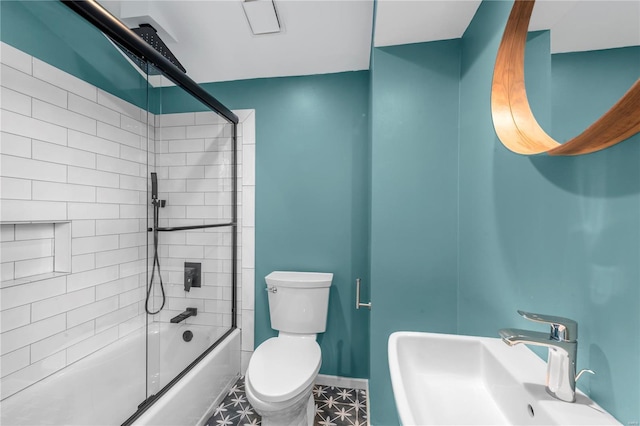 5089 Waterman Blvd, Saint Louis, MO 63108 - full bath featuring a sink, toilet, shower / bath combination with glass door, and baseboards