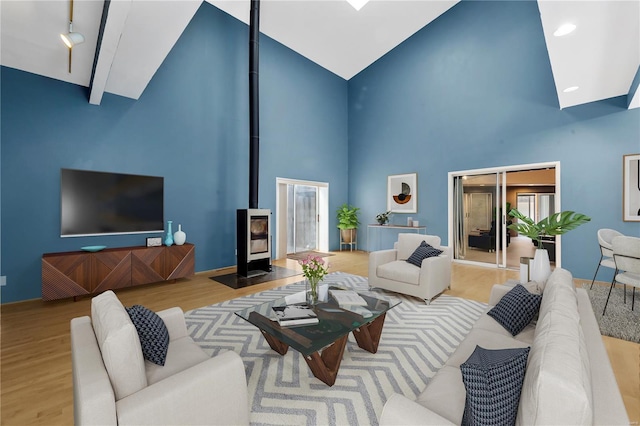 5089 Waterman Blvd, Saint Louis, MO 63108 - living room with a wood stove, high vaulted ceiling, and wood finished floors