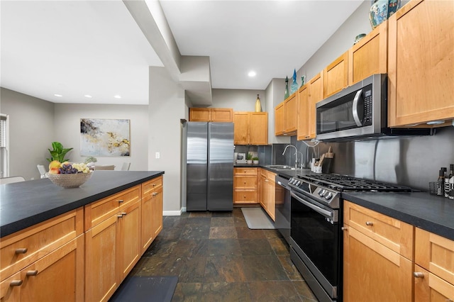 5089 Waterman Blvd, Saint Louis, MO 63108 - kitchen featuring appliances with stainless steel finishes, dark countertops, backsplash, dark stone finish flooring, and a sink