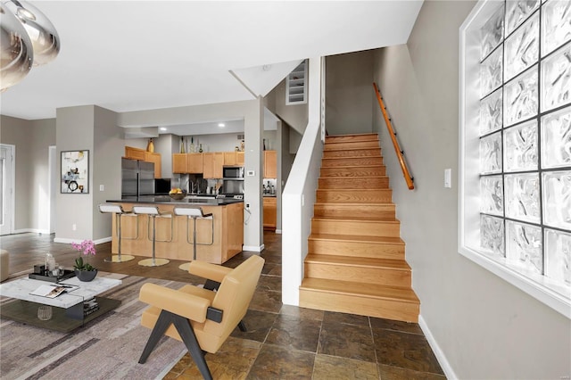 5089 Waterman Blvd, Saint Louis, MO 63108 - staircase with baseboards and stone finish floors