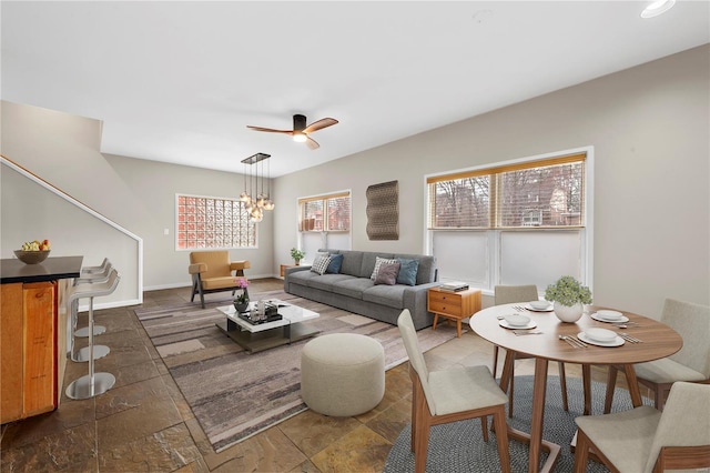 5089 Waterman Blvd, Saint Louis, MO 63108 - living room featuring a ceiling fan, a chandelier, and dark stone finish floors
