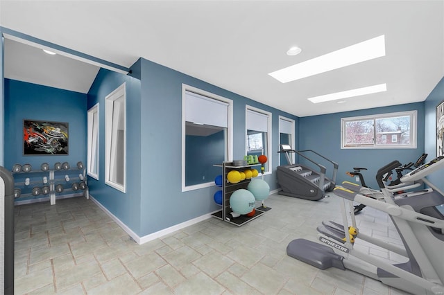 5089 Waterman Blvd, Saint Louis, MO 63108 - exercise area featuring a skylight, baseboards, and stone finish floors
