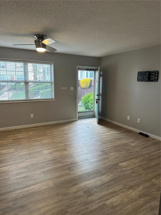 1459 Bobolink Pl, Saint Louis, MO 63144 - unfurnished room featuring wood finished floors, a textured ceiling, baseboards, and ceiling fan