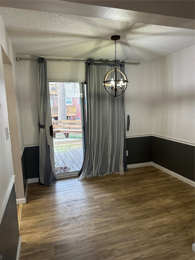 1459 Bobolink Pl, Saint Louis, MO 63144 - unfurnished dining area featuring a chandelier, a textured ceiling, wood finished floors, and baseboards