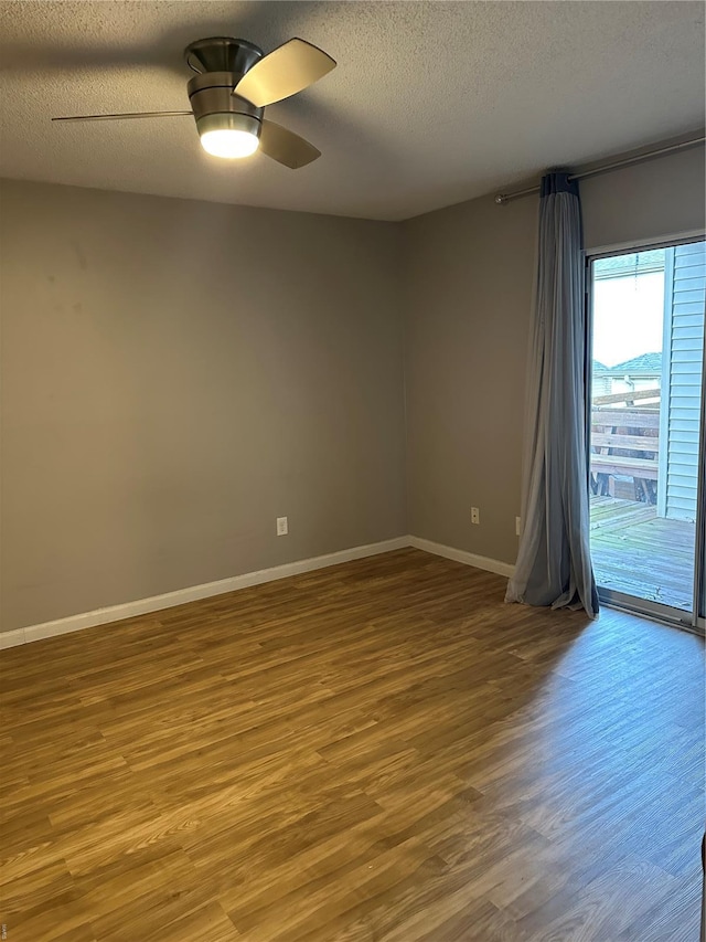 1459 Bobolink Pl, Saint Louis, MO 63144 - empty room featuring wood finished floors, a textured ceiling, baseboards, and a ceiling fan