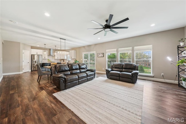 living area with baseboards, ceiling fan, dark wood-style flooring, and recessed lighting