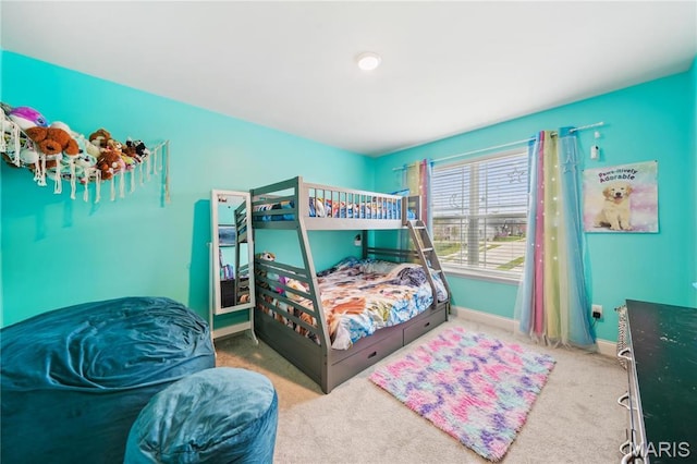 bedroom featuring carpet and baseboards