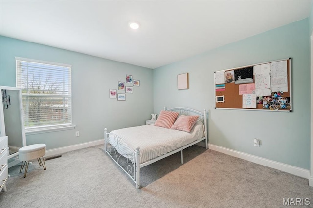carpeted bedroom with baseboards