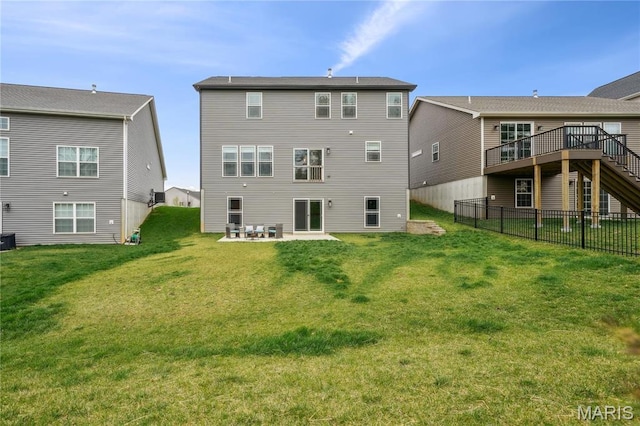 rear view of house featuring stairs, a wooden deck, and a patio area