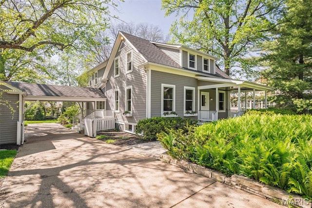 1211 S Geyer Rd, Saint Louis, MO 63122 - view of front facade with covered porch, concrete driveway, a shingled roof, and a carport