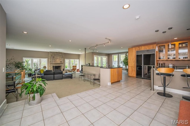 1211 S Geyer Rd, Saint Louis, MO 63122 - living area featuring a stone fireplace, recessed lighting, light tile patterned flooring, and baseboards